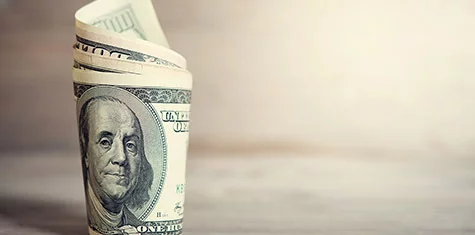 Roll of hundred dollar bills